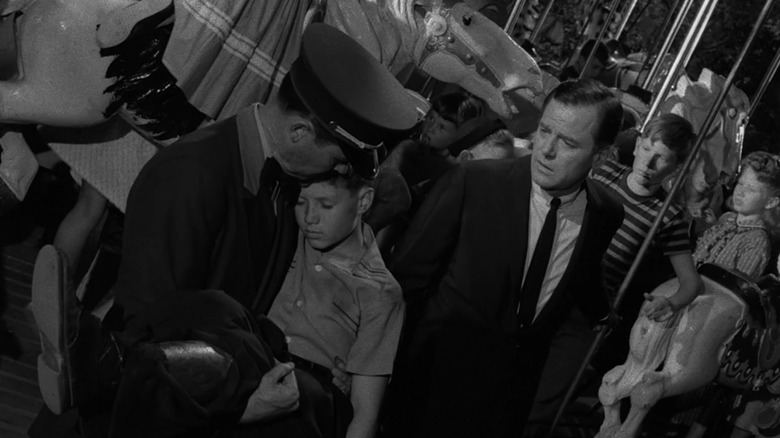 Martin Sloan standing next to a cop holding Martin's younger self in The Twilight Zone