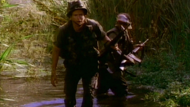 Two soldiers stepping through some marshland on The Twilight Zone
