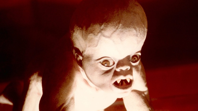 A mutant baby showing its fangs in It's Alive