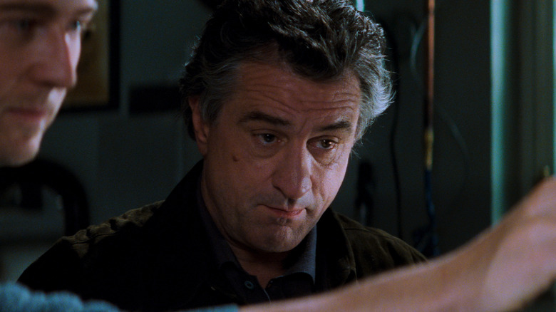 Robert De Niro as Nick Wells looks on with interest in The Score