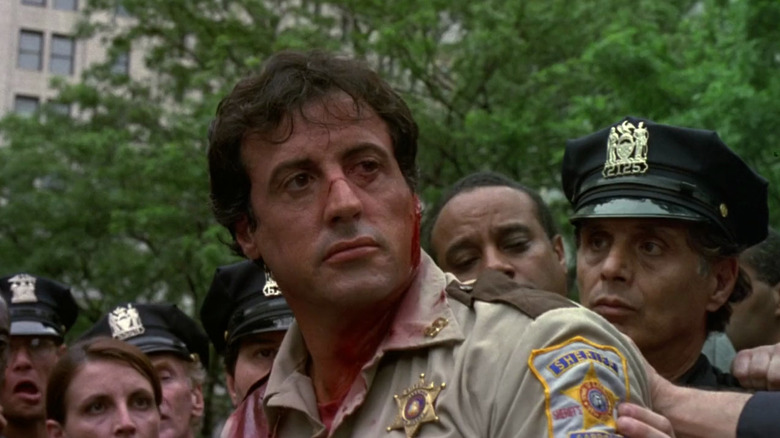 Sylvester Stallone as Freddy Heflin looking bloodied and battered in Cop Land
