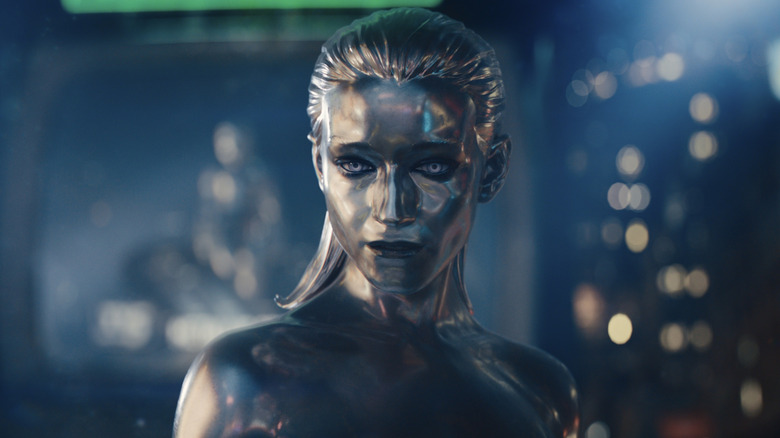 Silver Silver Julia Garner fly in front of a vast machine in Marvel Studios' The Fantastic Four: First Steps.