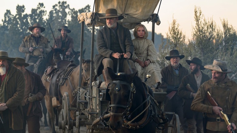 Captain Kiss and Johanna on a carriage with an army around them in News of the World