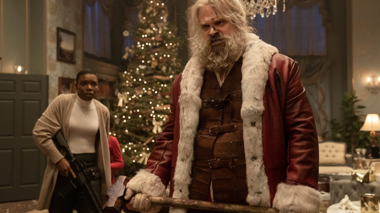 A bloody Santa holds a sledgehammer ready for violence in Violent Night