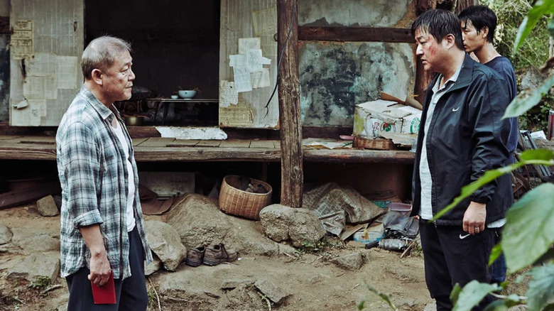 Jun Kunimura as The Stranger and Kwak Do-won as Jong-goo face off in The Wailing
