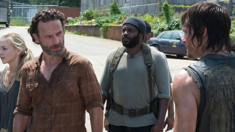 Rick, Tyreese, and Daryl standing together with other survivors in The Walking Dead