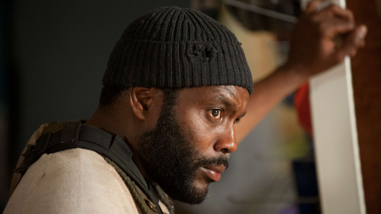 Tyreese leaning his left hand against a support beam in The Walking Dead