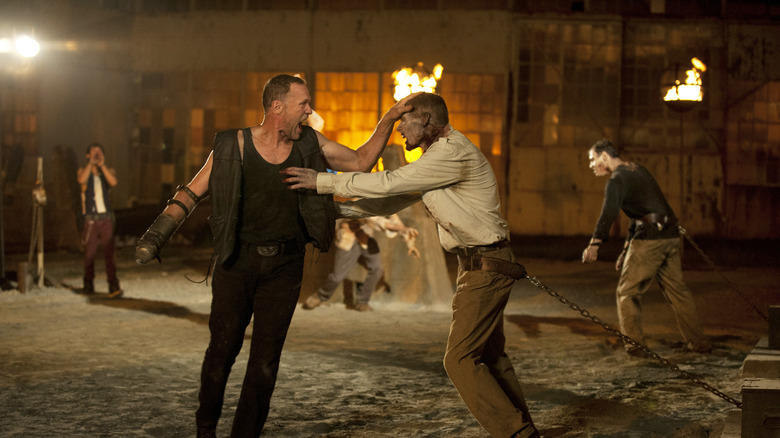 Merle Dixon holds off a chained zombie in The Walking Dead