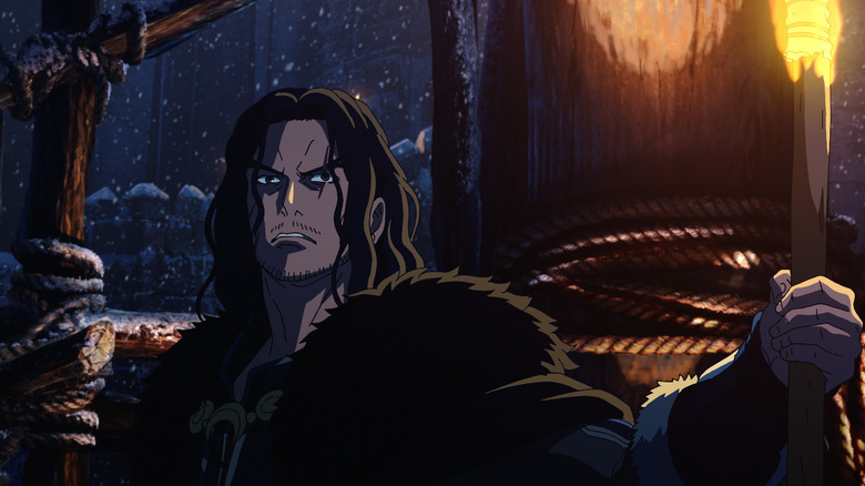 Luke Pascqualino as Wulf holding a torch in the snow in The Lord of the Rings: The War of the Rohirrim