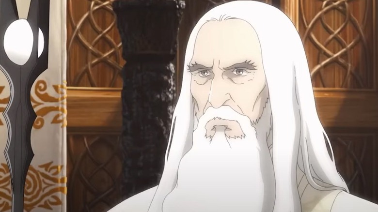 Christopher Lee as Saruman holding his staff in The Lord of the Rings: The War of the Rohirrim