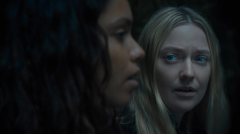 Dakota Fanning as Mina in the background staring at Georgina Campbell as Ciara in the foreground during a tense moment in The Watchers
