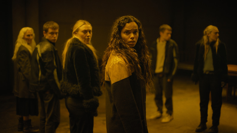 Georgina Campbell as Ciara, Dakota Fanning as Mina, Oliver Finnegan as Daniel, and Olwen Fouéré as Madeline nervously looking off-screen in The Watchers