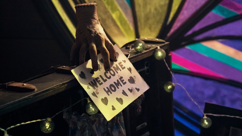 Thing holds a welcome message for Wednesday after she wakes up from her coma in Wednesday season 2