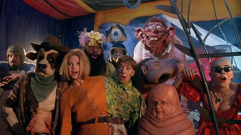 A group of mutants and freaks under a big top in a group shot from the movie Freaked