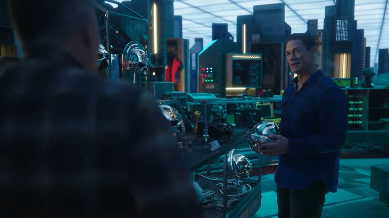 John Cena as Christopher Smith, holding a Peacemaker helmet in Peacemaker