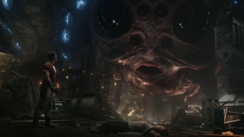 John Cena as Peacemaker, looking up at the alien cow in Peacemaker