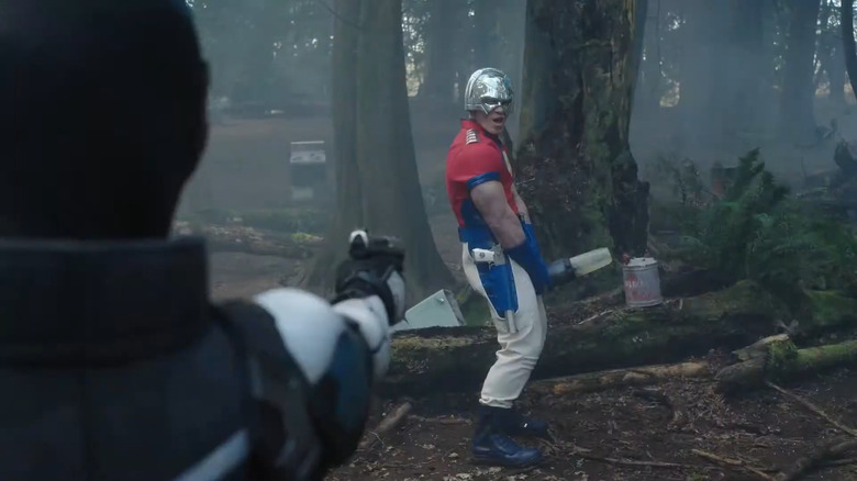 John Cena as Peacemaker, holding a blender in front of his crotch for Vigilante to shoot at in Peacemaker