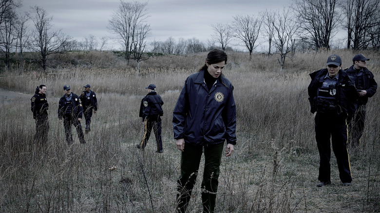 Amanda and other cops find a body in a field in The Whisper Man