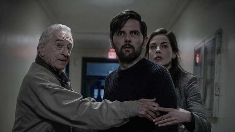 Pete, Tom, and Amanda in a hallway in The Whisper Man