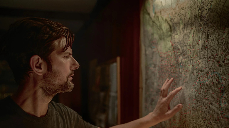 Tom looks at a map in The Whisper Man