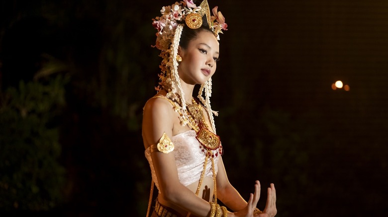 Mook performing in a Thai costume in The White Lotus
