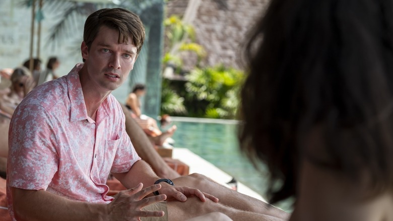 Saxon looking at Chloe horrified by the pool on The White Lotus