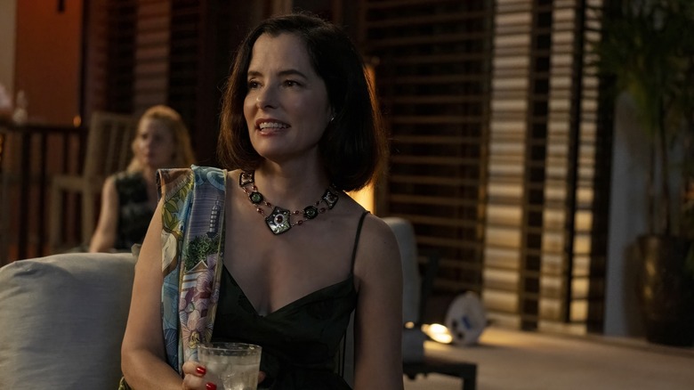 Victoria smiling and holding a drink on The White Lotus