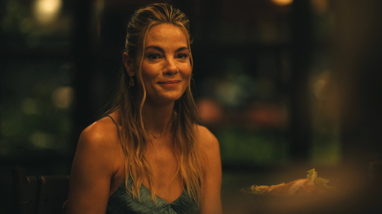 Jaclyn at a dinner table smiling on The White Lotus