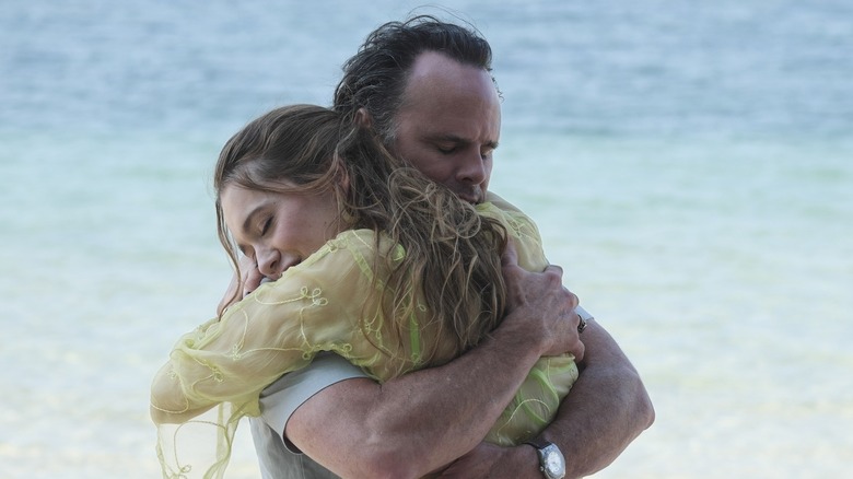 Rick and Chelsea embracing on the beach in The White Lotus