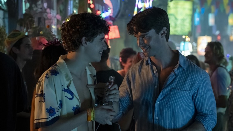 Lochlan and Saxon laughing at the full-moon party in The White Lotus