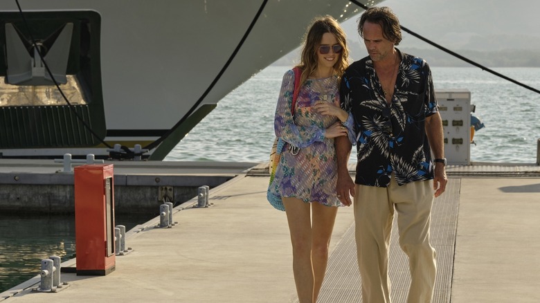 Aimee and Rick arm in arm on a dock in The White Lotus