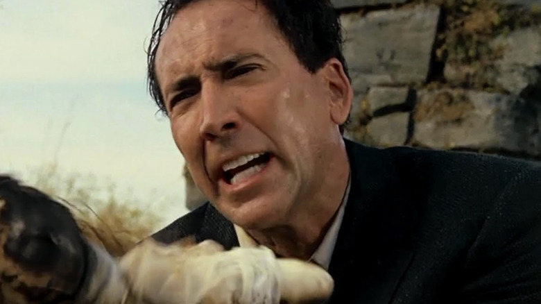 Edward holds a doll and looks upset in The Wicker Man (2006)