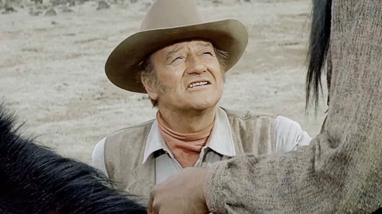 John Wayne's Colonel John Henry Thomas looks up at a man on a horse in The Undefeated