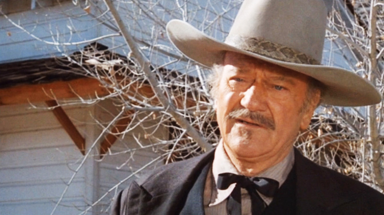 John Wayne's J.B. Books is seen standing outside a white house in The Shootist