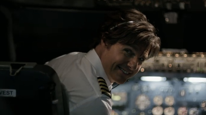 Tom Cruise's Barry Seal smiles as he sits in a cockpit in American Made