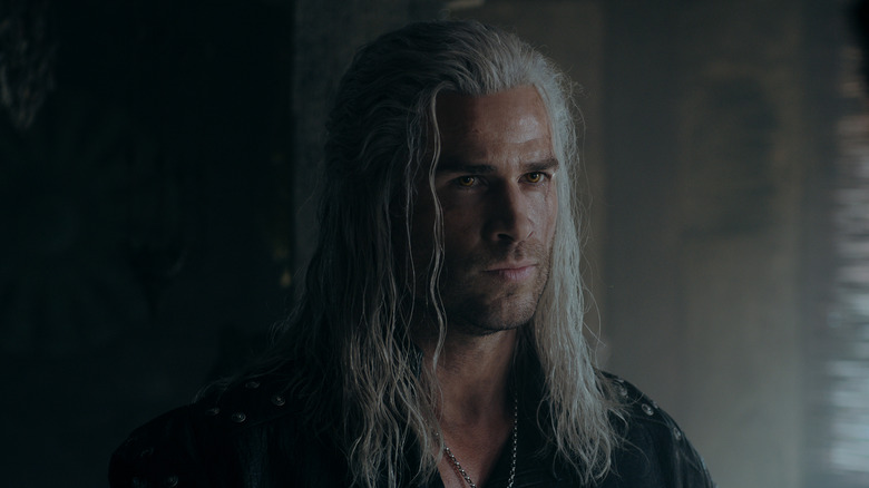 Geralt of Rivia standing in a dark room on 'The Witcher'