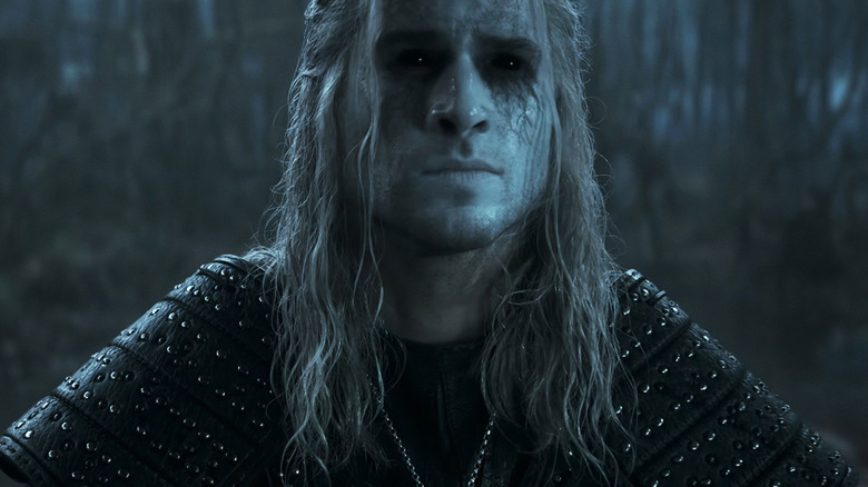 Liam Hemsworth as Geralt stands in a swamp with his eyes black in The Witcher