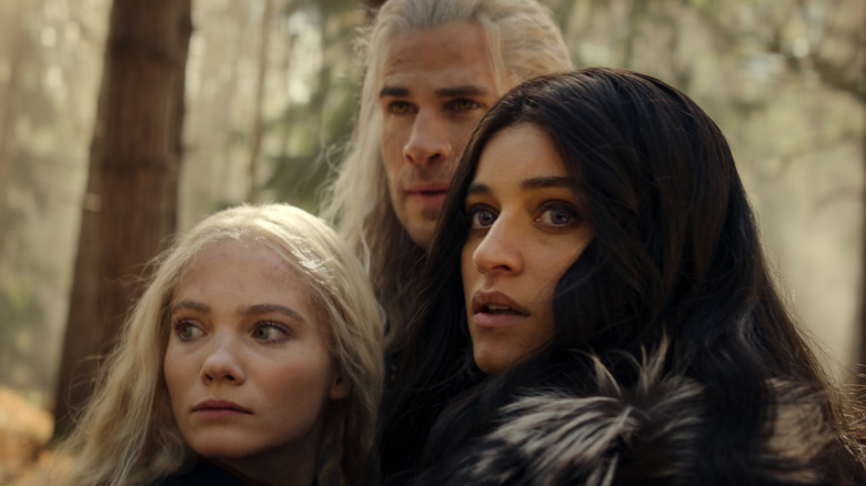 Freya Allan as Ciri, Liam Hemsworth as Geralt, and Anya Chalotra as Yennefer looking concerned on The Witcher