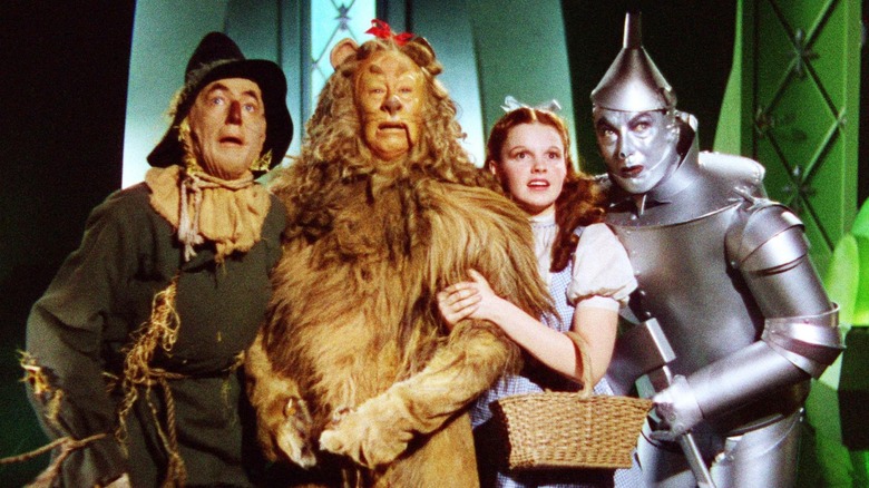 Scarecrow, the Cowardly Lion, Dorothy, and the Tin Man meeting Oz in The Wizard of Oz