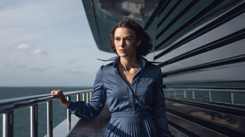 Lo walking along the railing of the ship in The Woman in Cabin 10