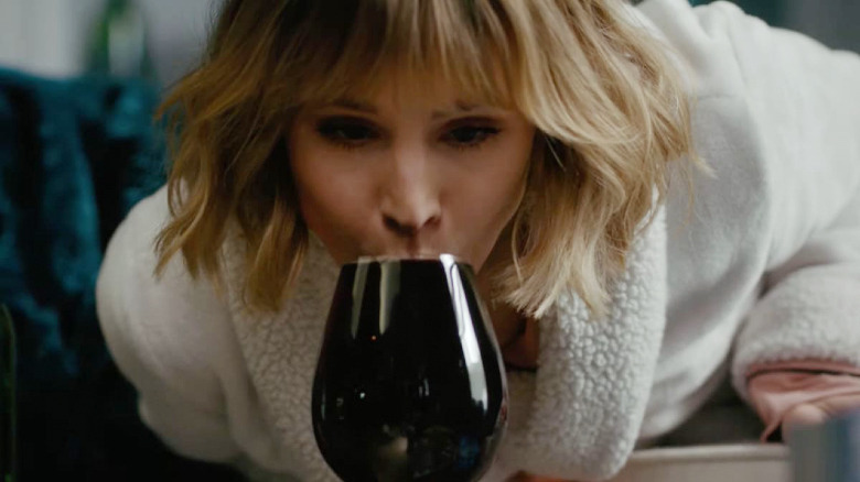 Kristen Bell drinking wine in The Woman in the House