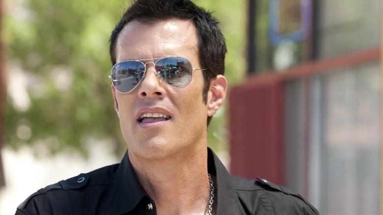 A spiky-haired man in sunglasses from Crash