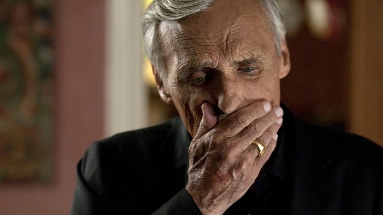 Ben Cendars covering his face in Crash