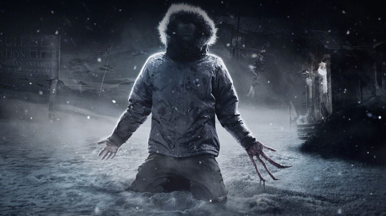 The 2011 Thing kneeling in snow