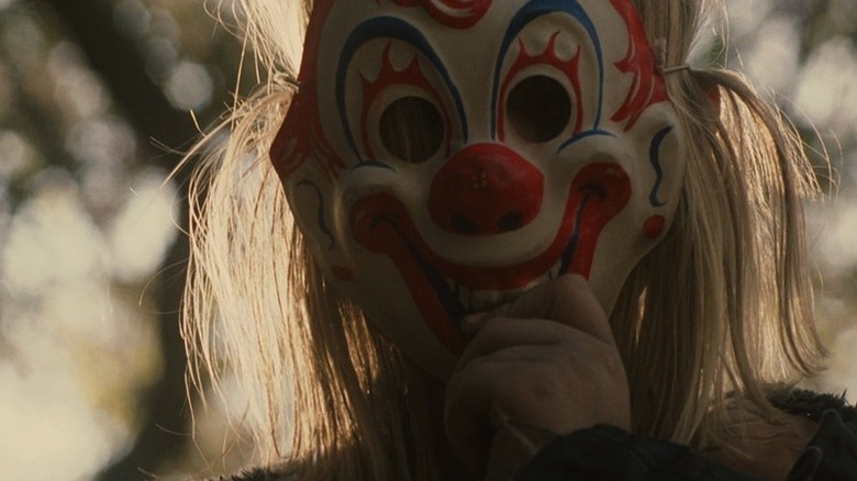 Young Michael Myers wearing clown mask