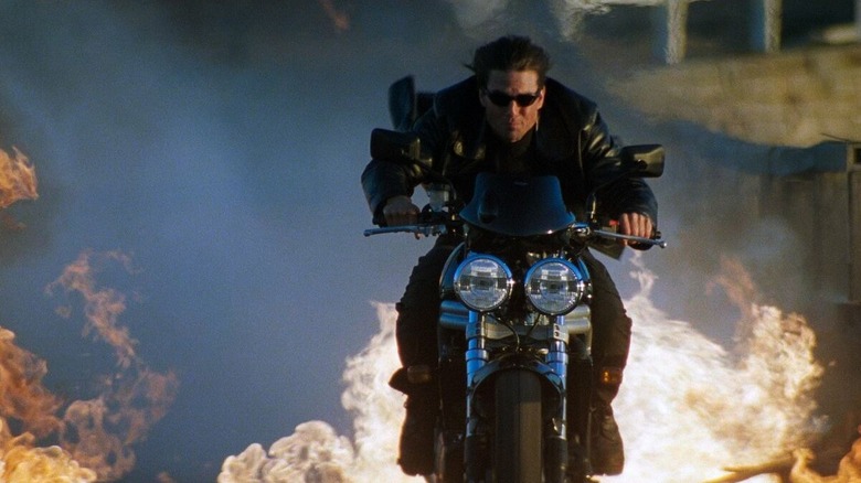 Tom Cruise as Ethan Hunt jumping his motorcycle in Mission: Impossible 2