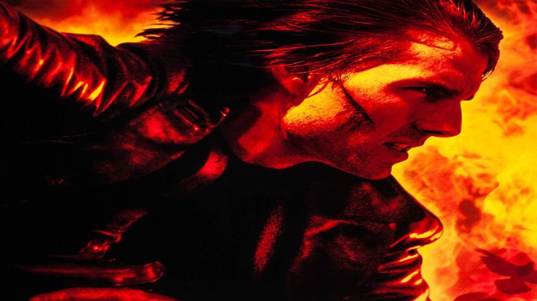 Tom Cruise as Ethan Hunt bathed in fire on the poster for Mission: Impossible 2