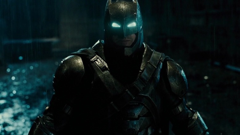 Ben Affleck as Batman in his metal suit walking in the rain in Batman v Superman: Dawn of Justice