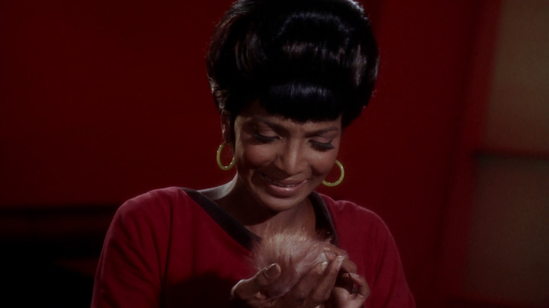 Nichelle Nichols as Uhura, holding a Tribble on the original Star Trek