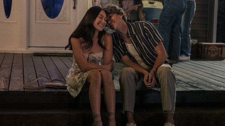 Belly and Jeremiah sitting on the front step of a house smiling and cuddling on The Summer I Turned Pretty
